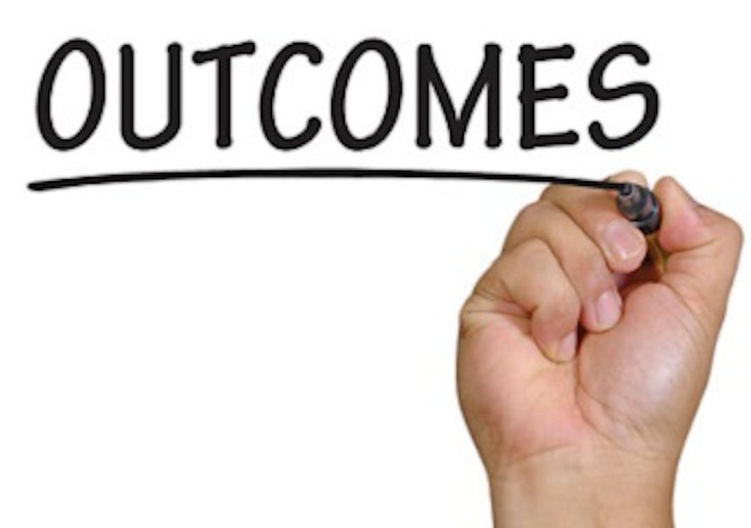 hand writing the word outcomes