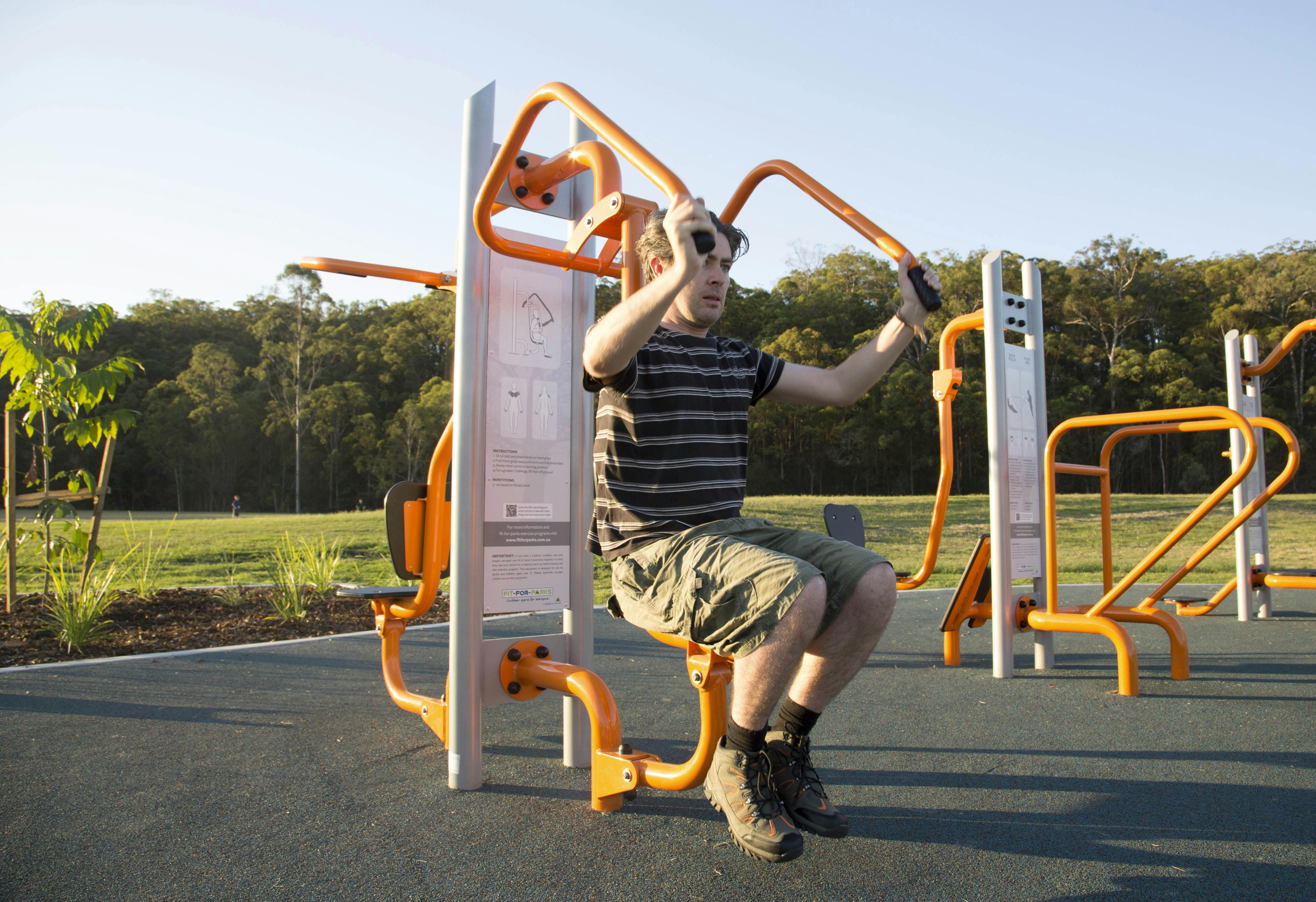 Image of a person using outdoor gym equipment