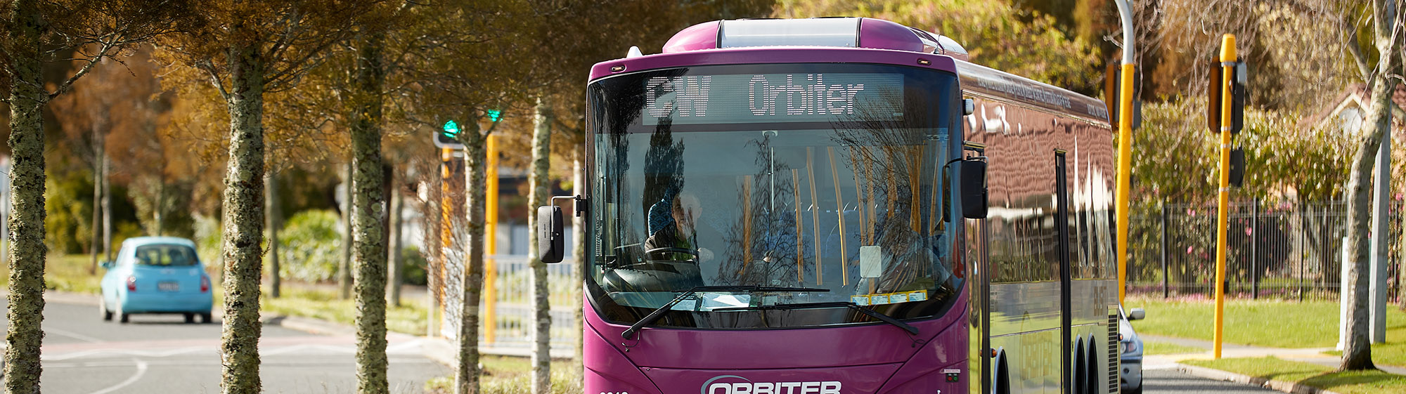 Image of a purple CW Orbiter bus on the road