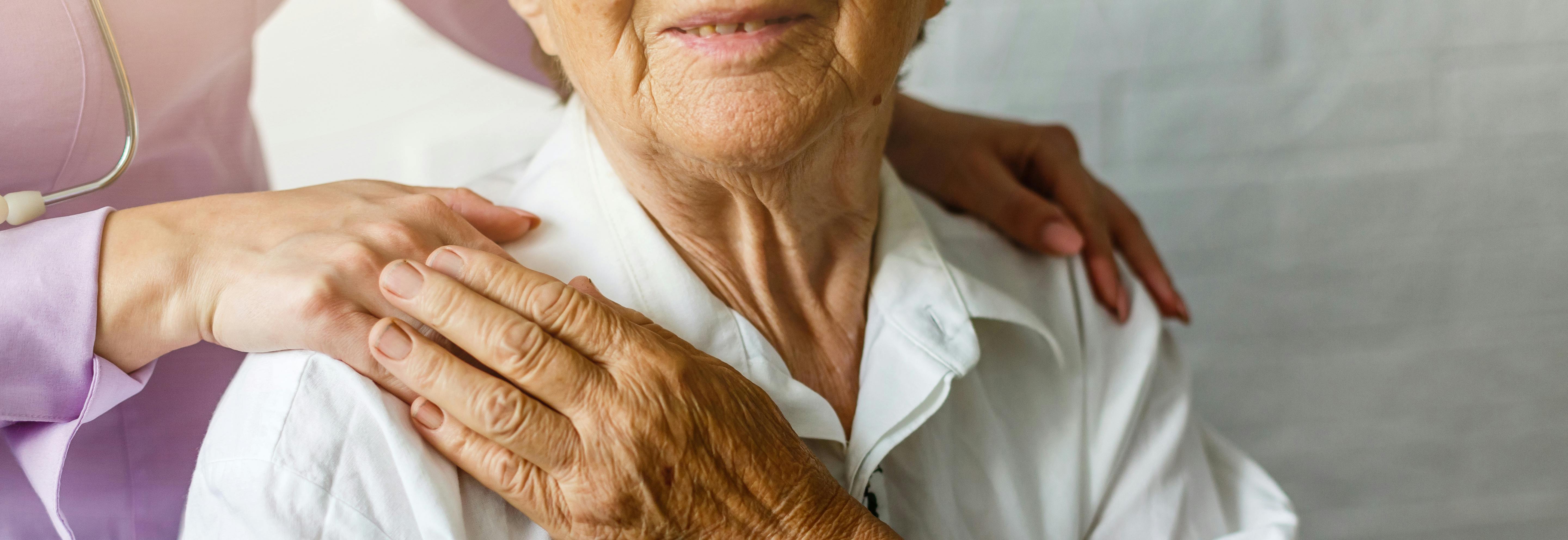 Elderly woman receiving care from a health professional