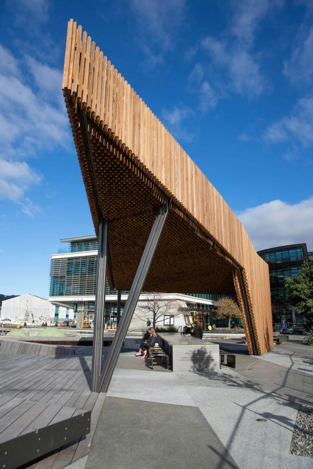 Woman sitting underneath sculpture in North Kumototo location
