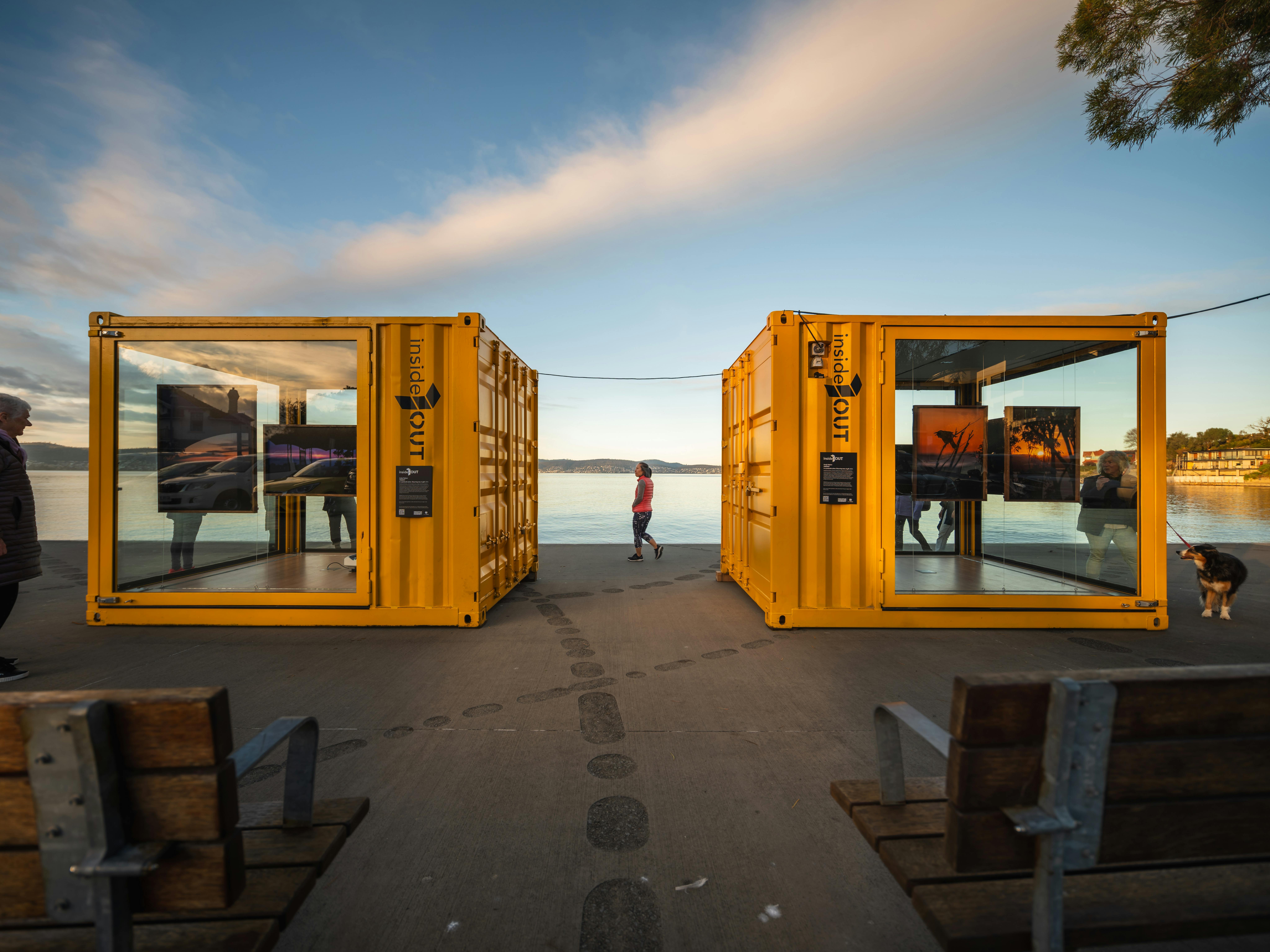 Woman walking between two artistic installations