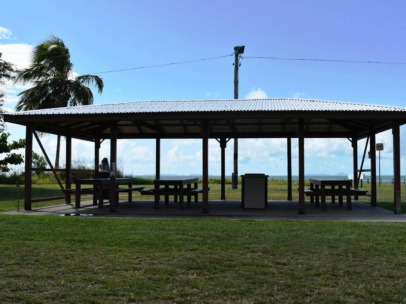 Picnic area - This photograph is looking north towards the beach showing the elevation of the shelter.  This shelter contains a double BBQ as well as three older style timber picnic settings.  