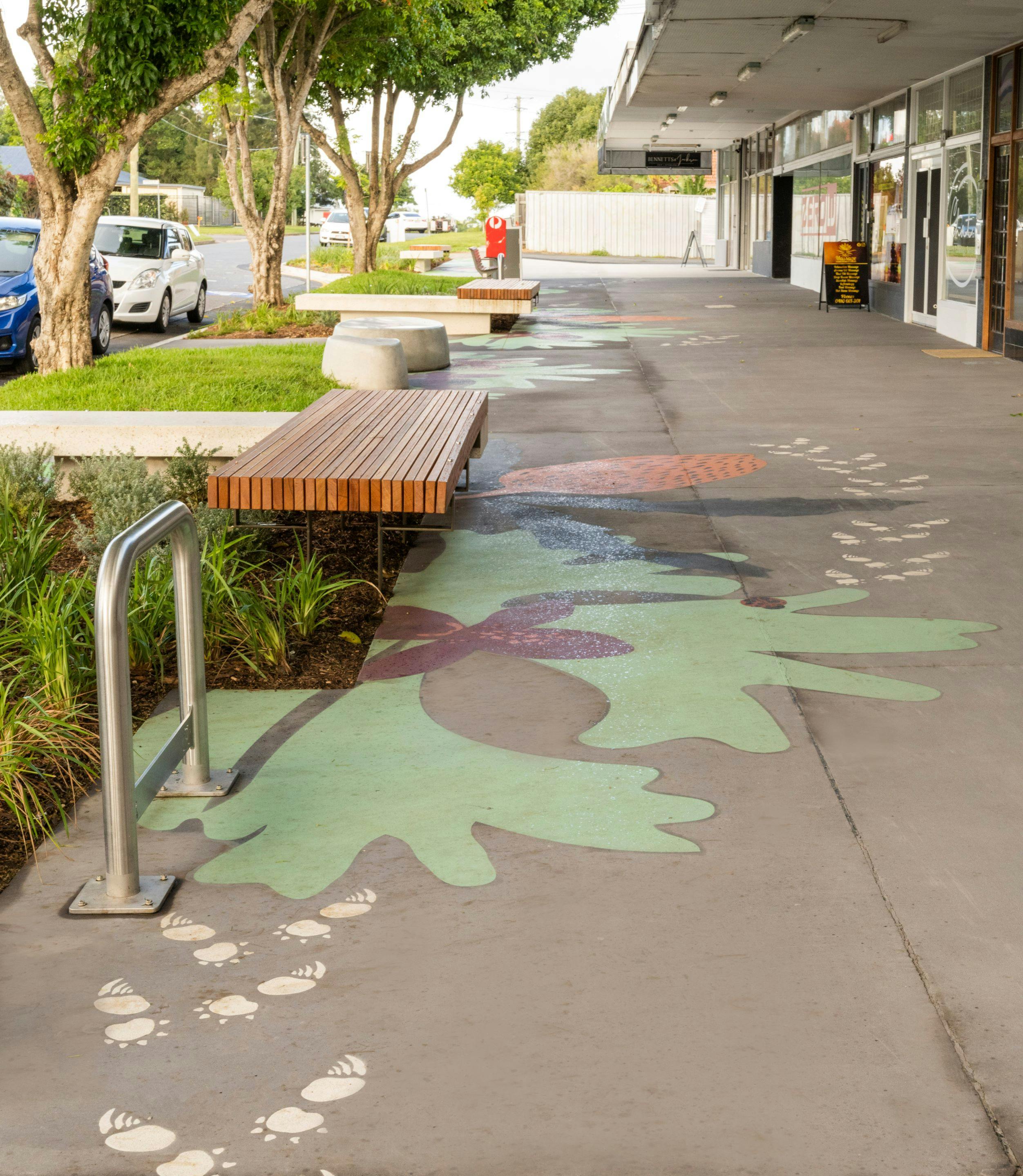 Lumley St looking east at upgraded footpath with new seating areas incorporating custom seating, turf and planting beds and colourful 'Echidna Magic' pavement designs.