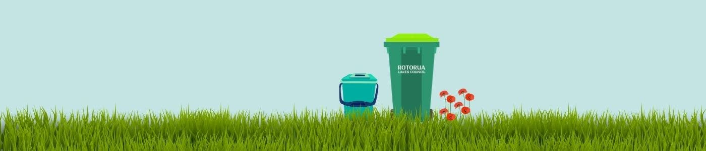 Green grass with green organic collection bins