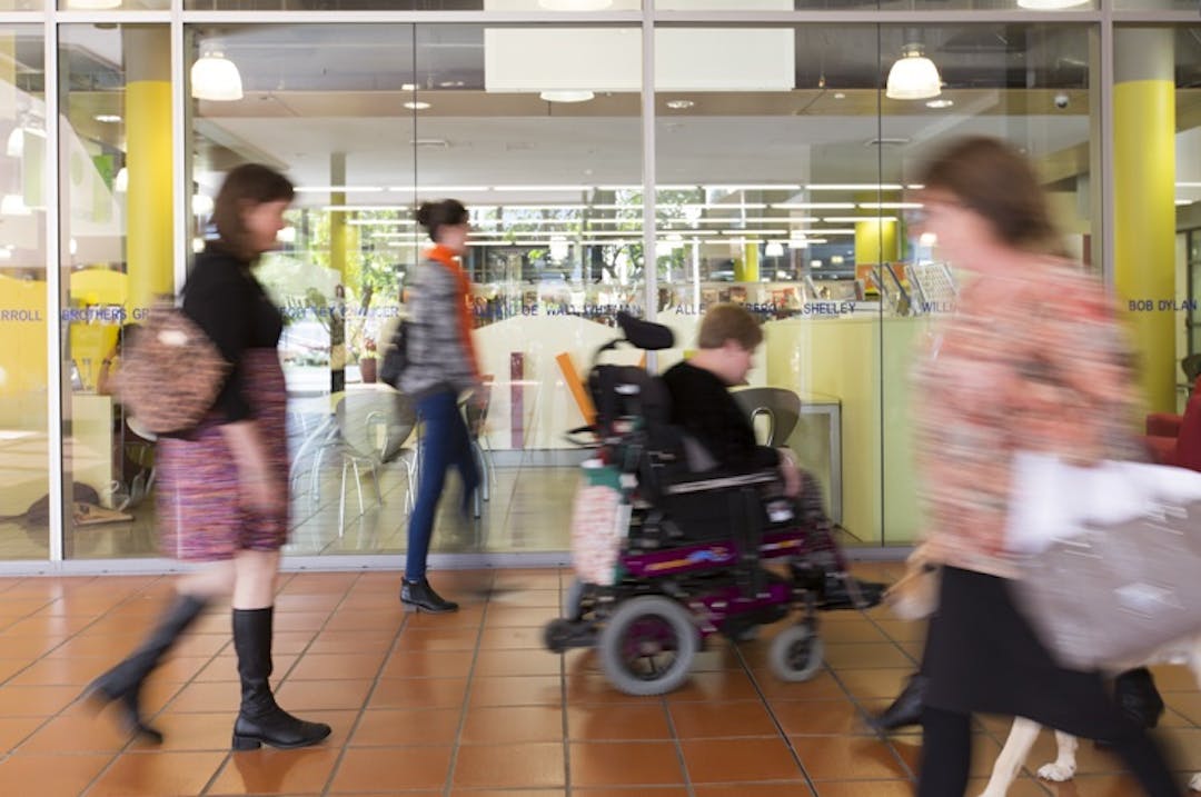 People with disabilities and others walking