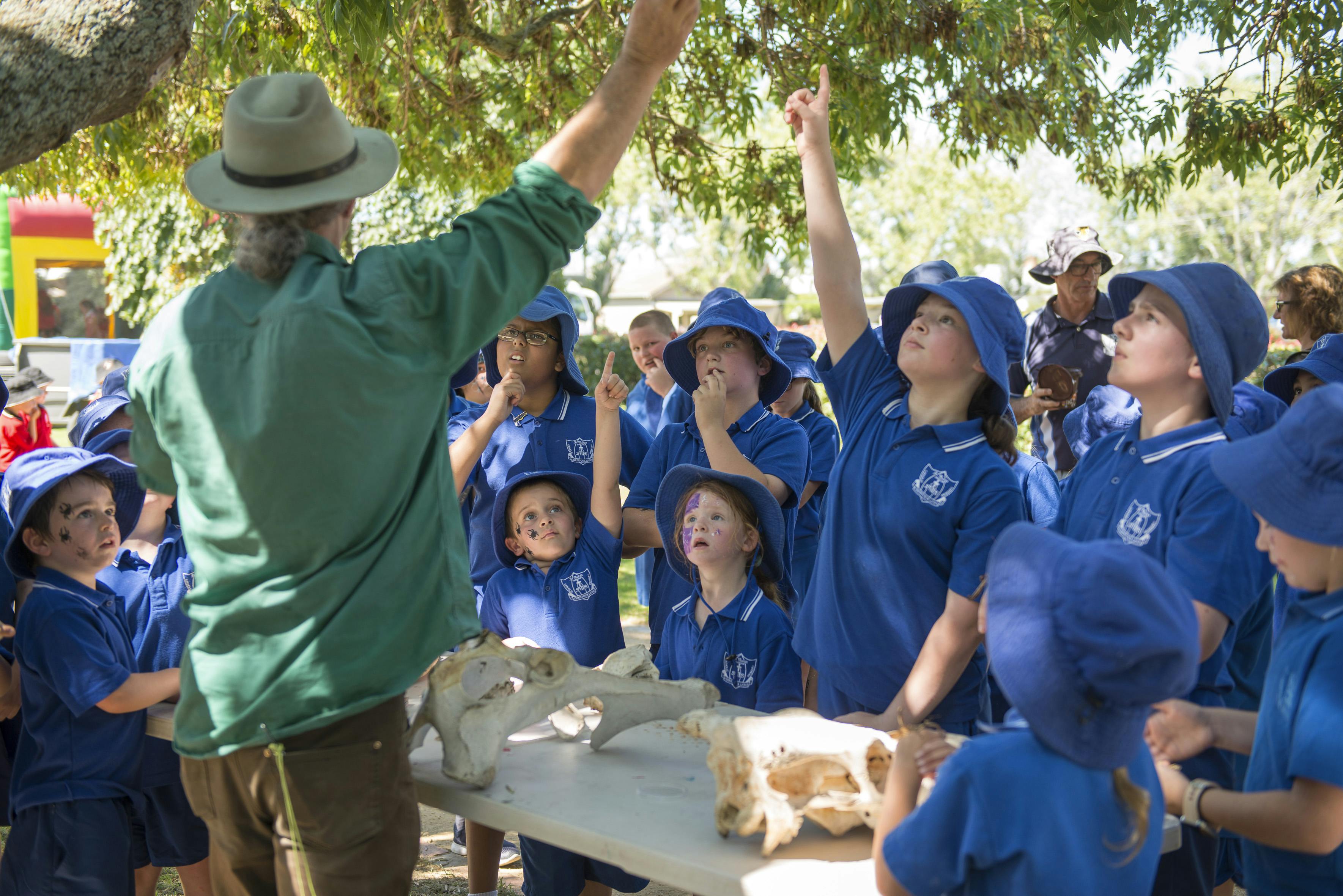 Group of children gathered around listening to an adult at Parks Week at Yarram Memorial Park 2020