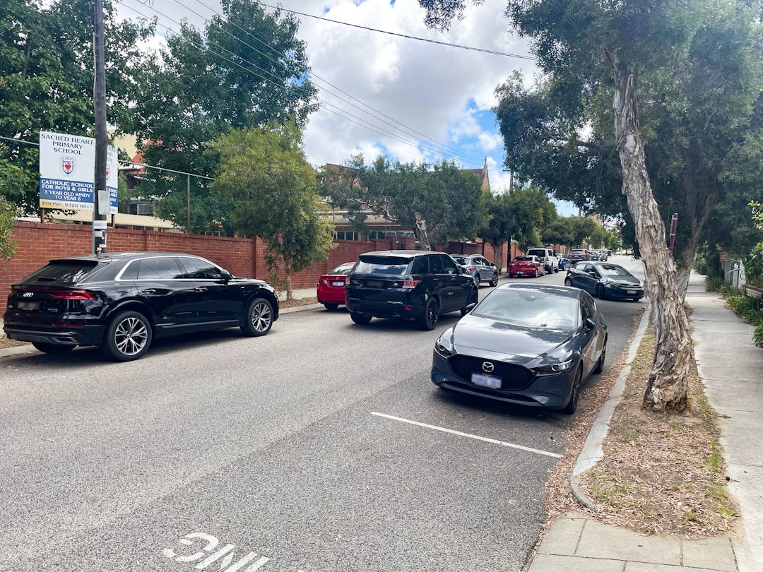 Cars driving and parking along Harold Street