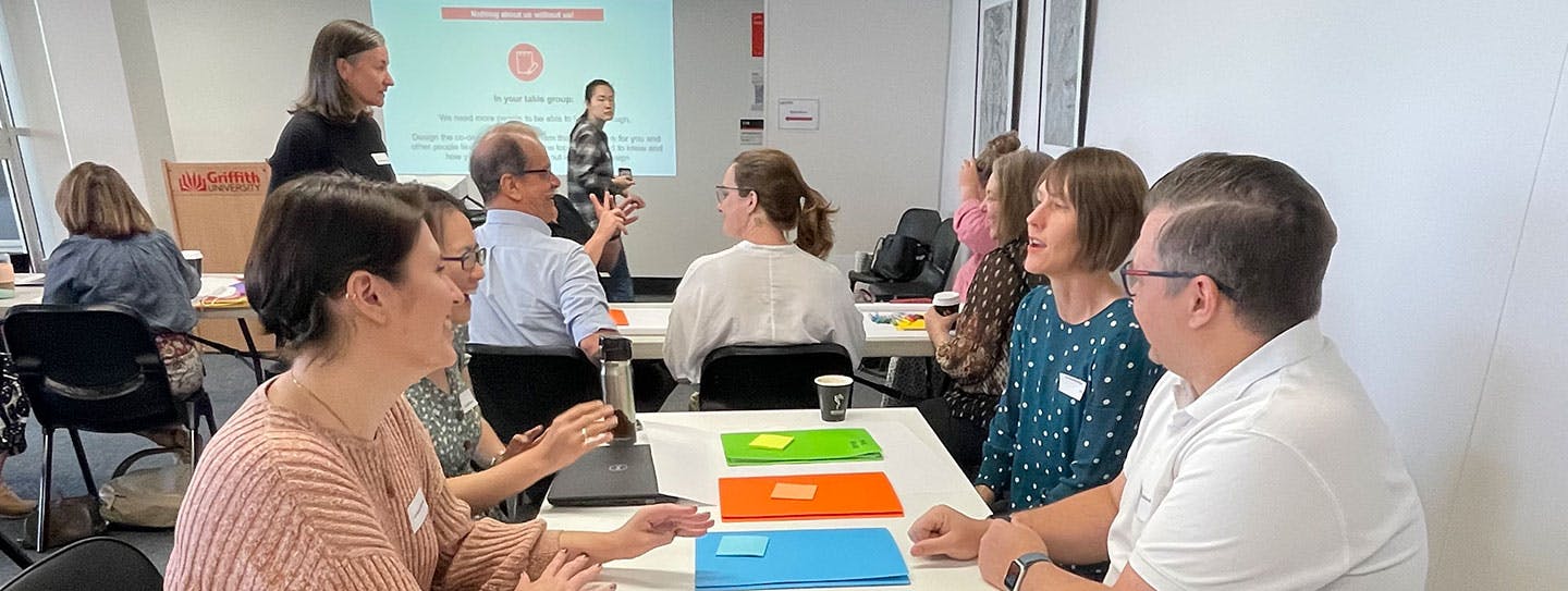 A group of researchers with and without disability working together in a co-design session.