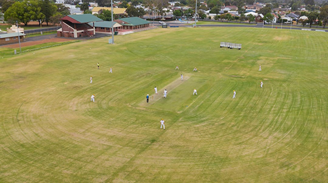 Aerial view of Harvey Recreation Ground with community members playing cricket.