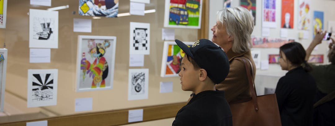 Family looking at artworks at Waverley Youth Art Prize
