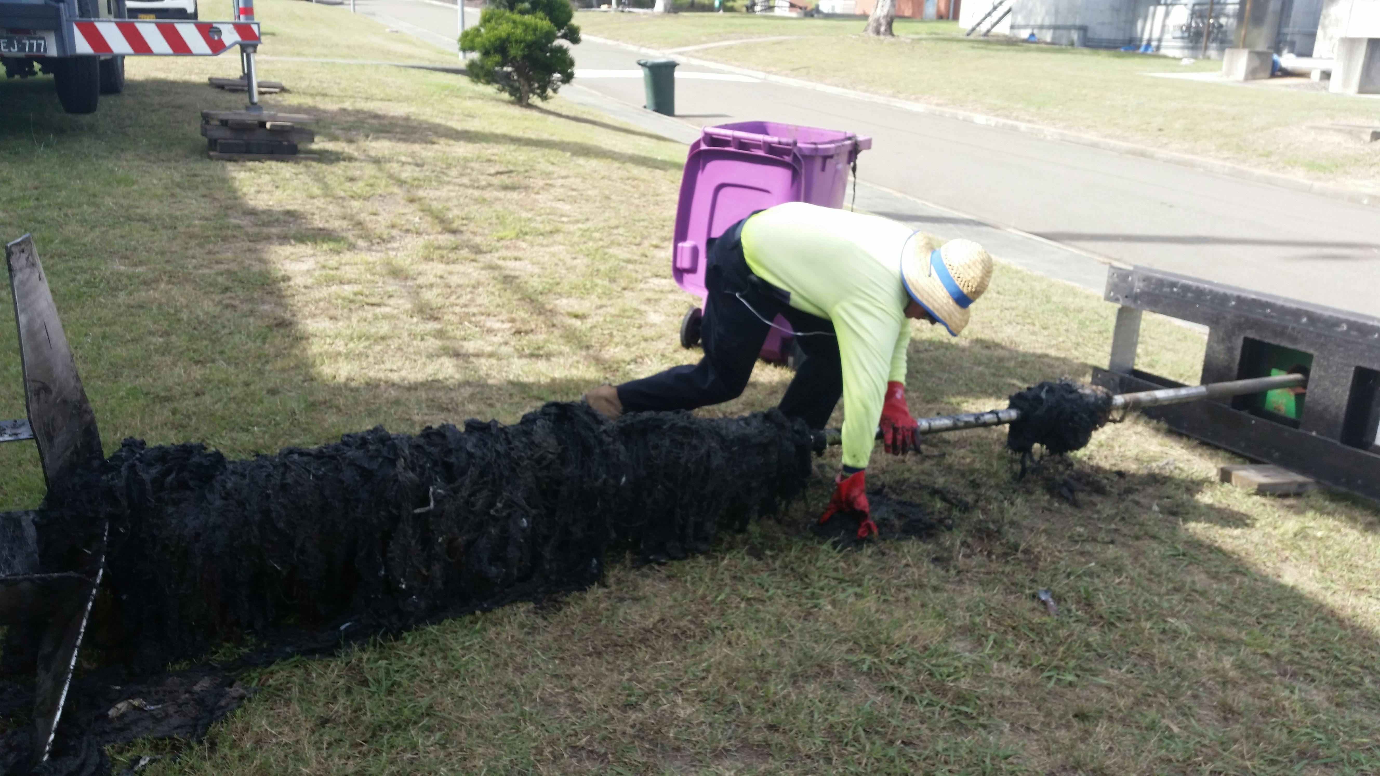 Staff manually removing wipes
