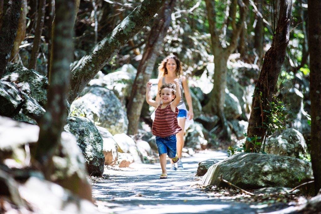 Mum And Son Running Through Trees