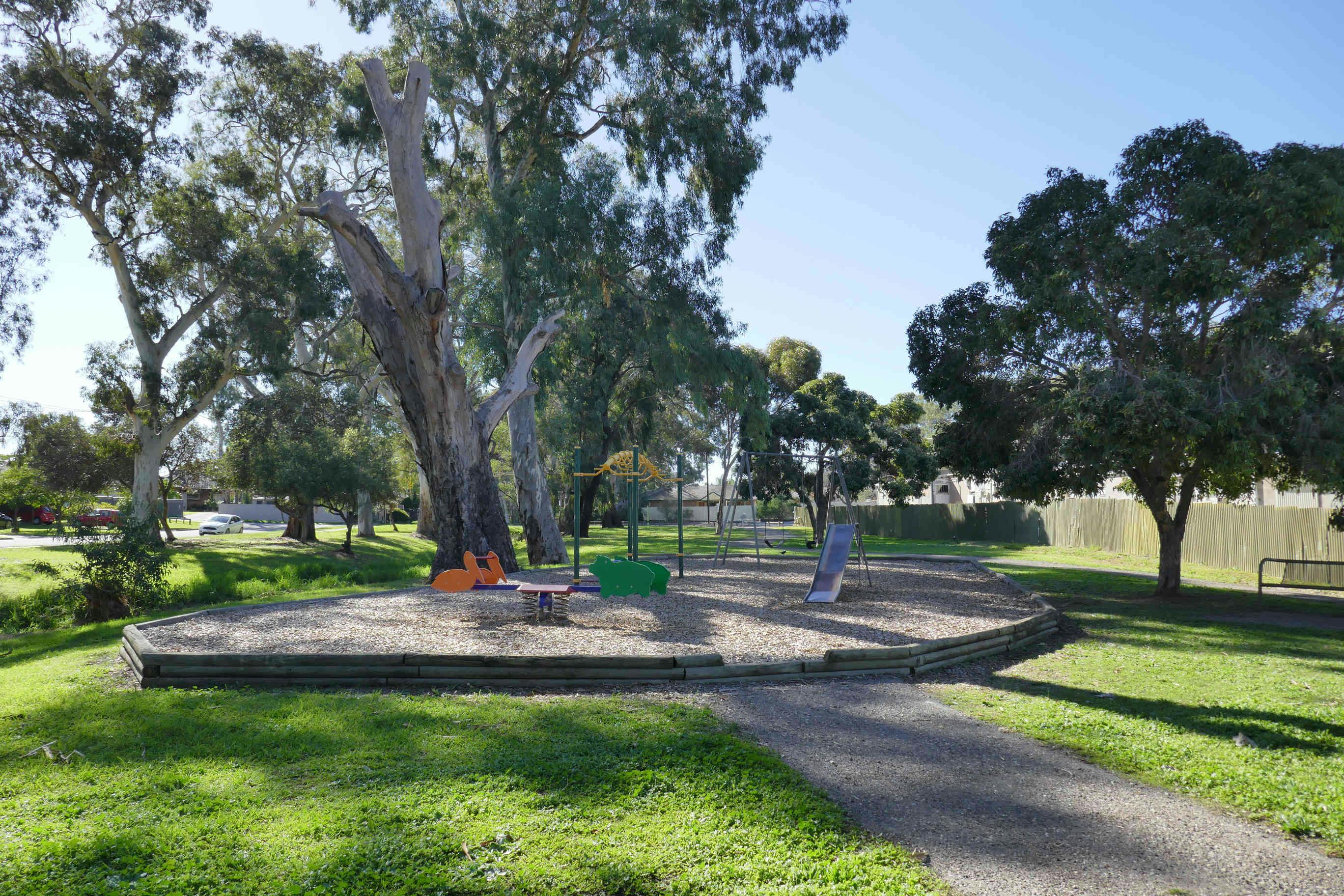 Existing Ridgehaven Reserve Playground view of slippery dip and spring seesaw.jpg