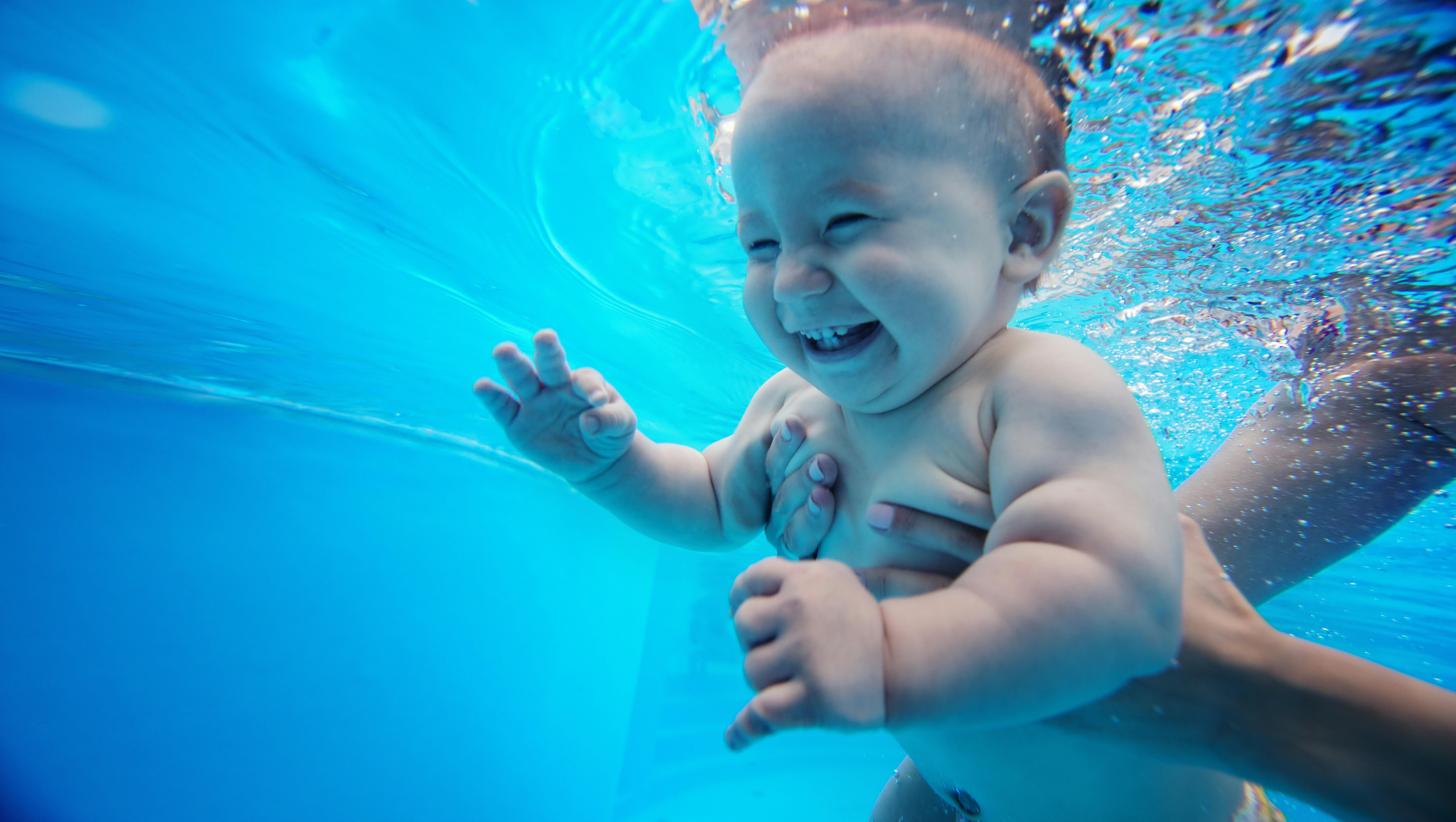 baby learning to swim