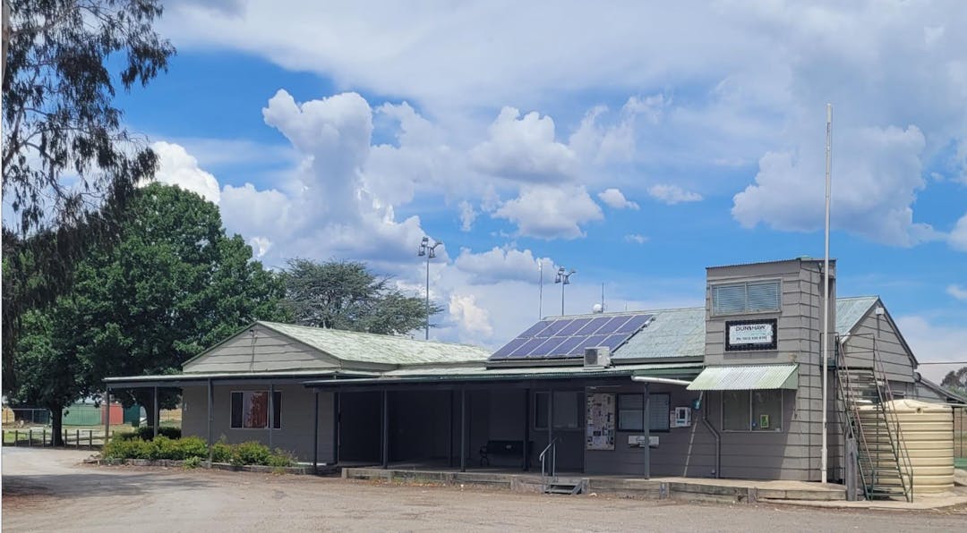 Murrumbateman Recreation Hall with empty car park in foreground and blue skies with clouds 