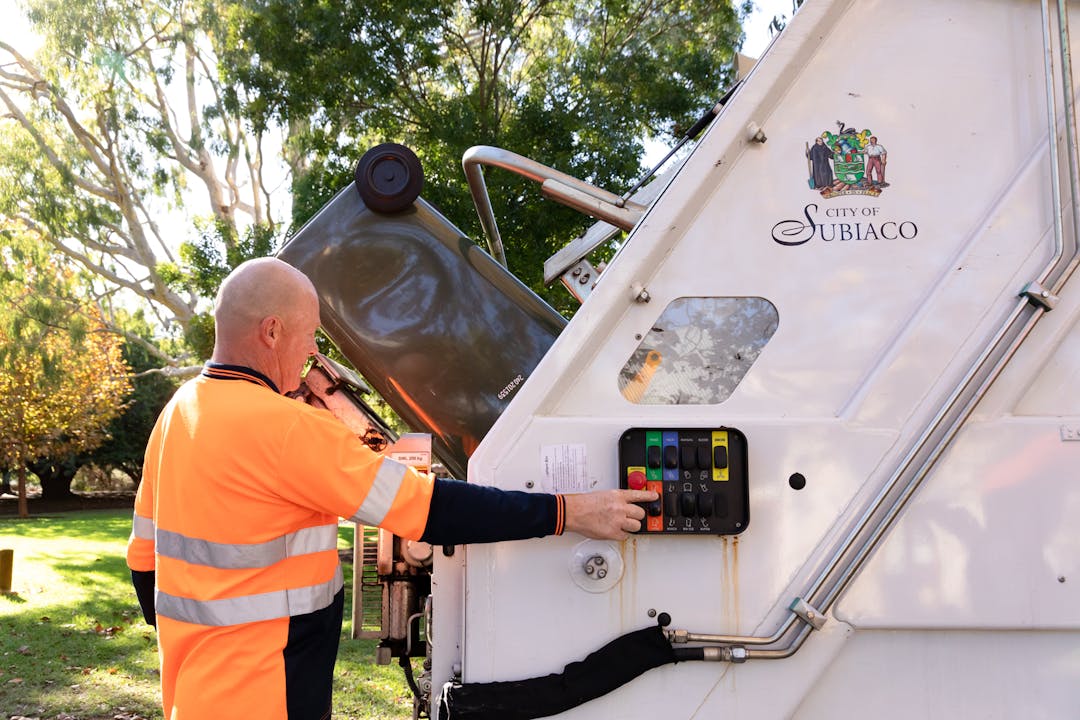 Waste staff with truck and recycling bin