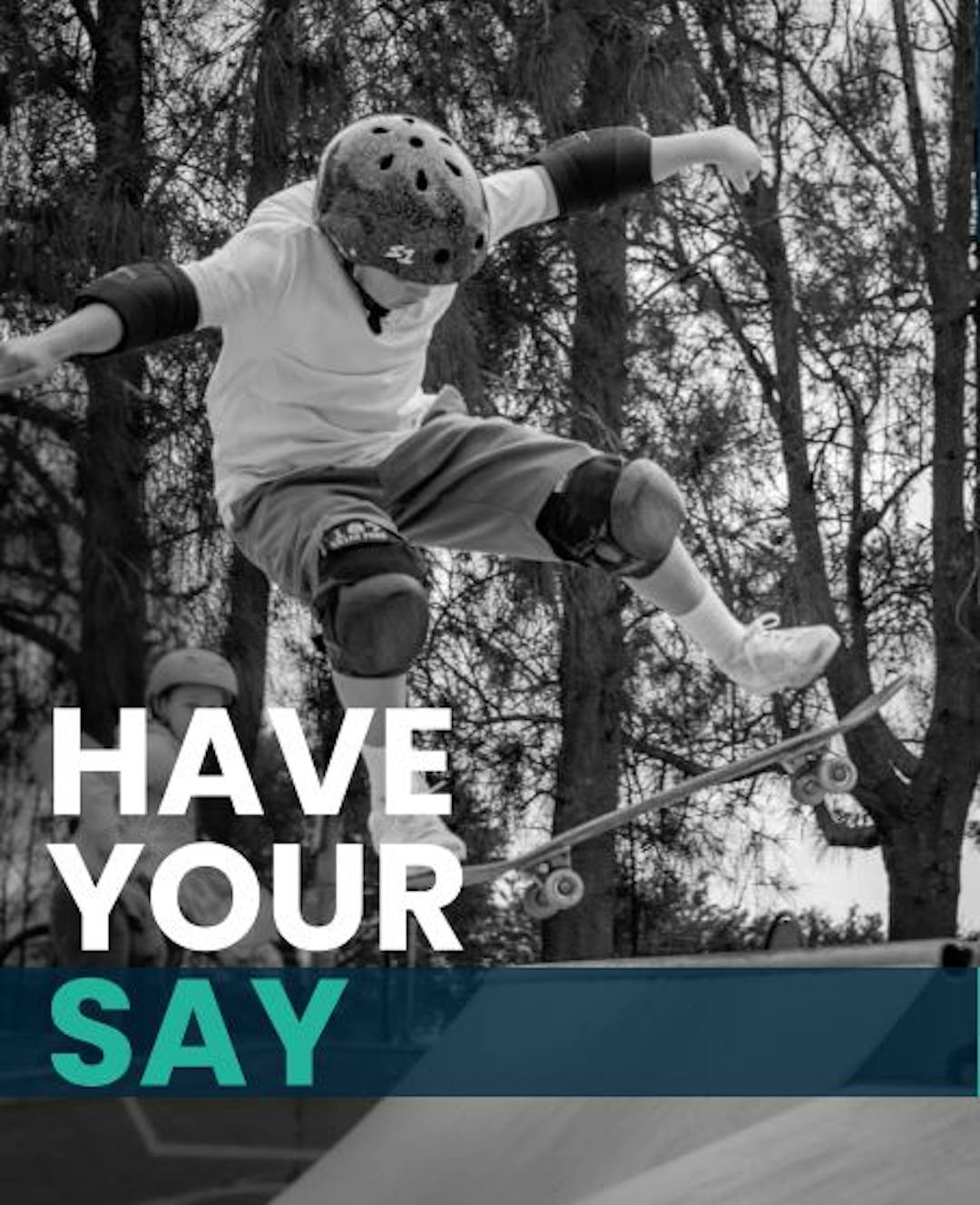 Kid riding a skateboard on a skate park ramp