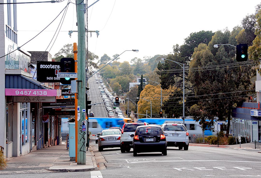 Lower Plenty Road level crossing with boom gate down and train crossing