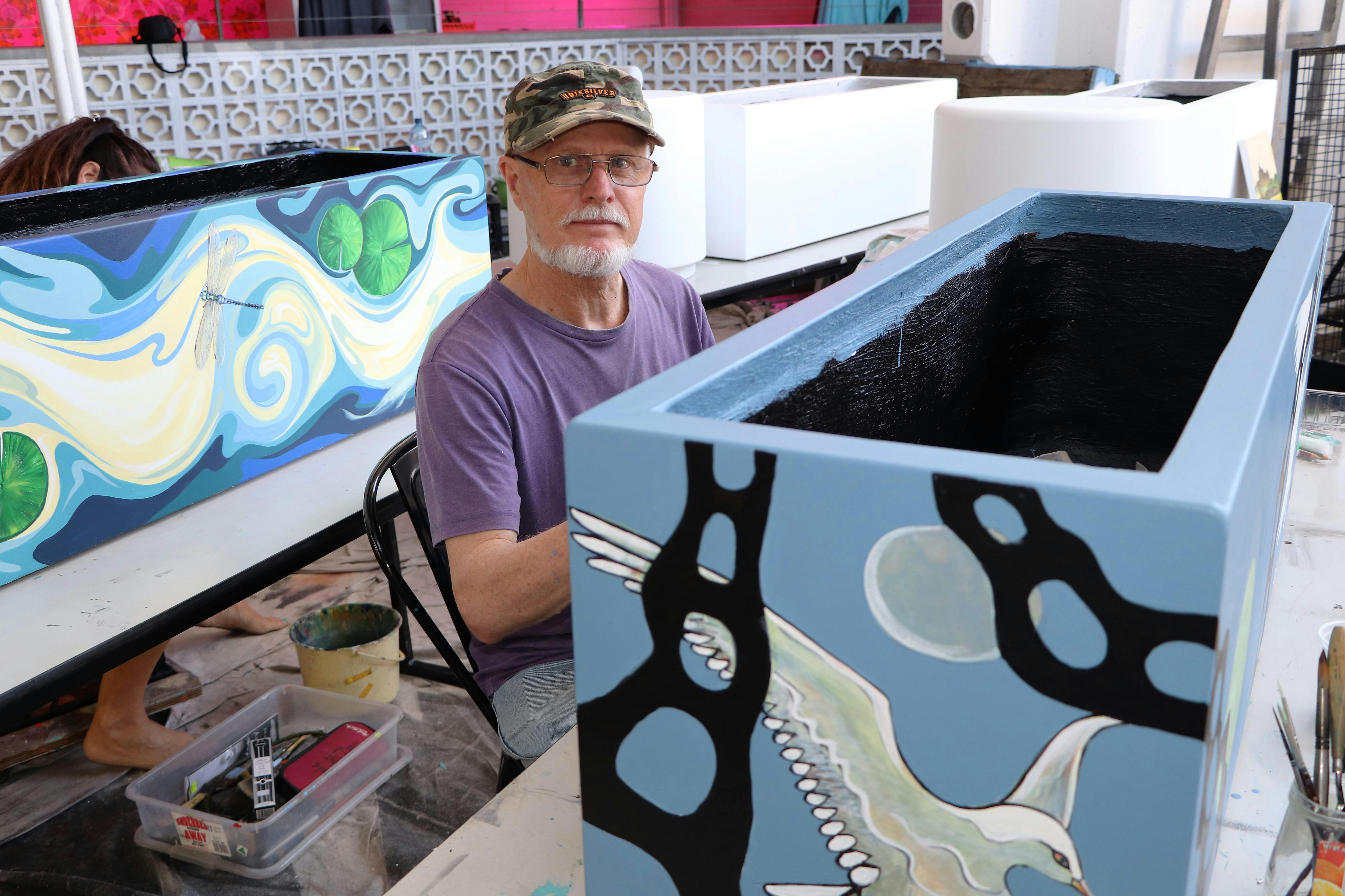 Phillip Hay paints his air themed planter box