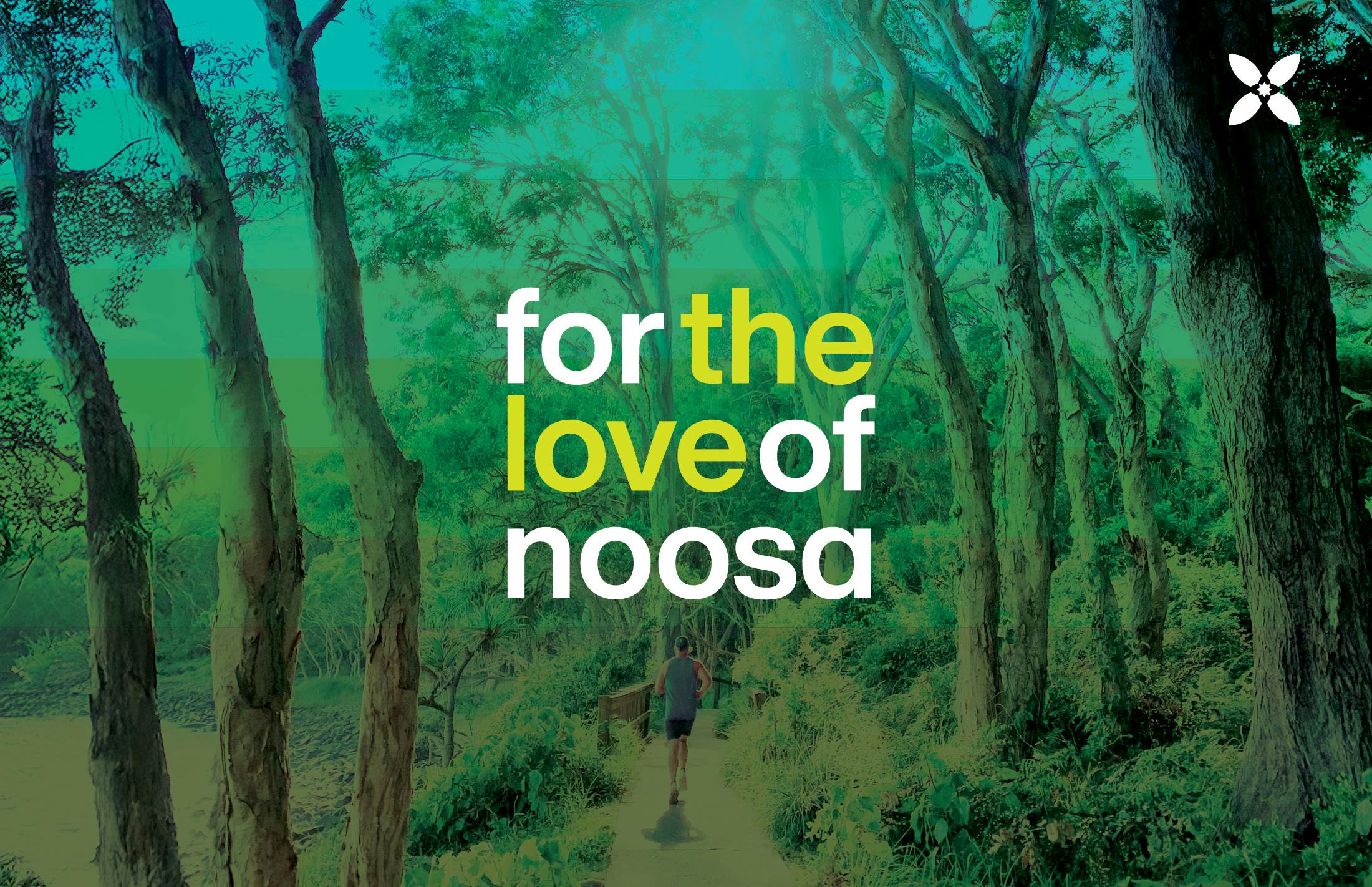 Two mountain bike riders enjoying a scenic ride through a lush green track in the Noosa Hinterland.