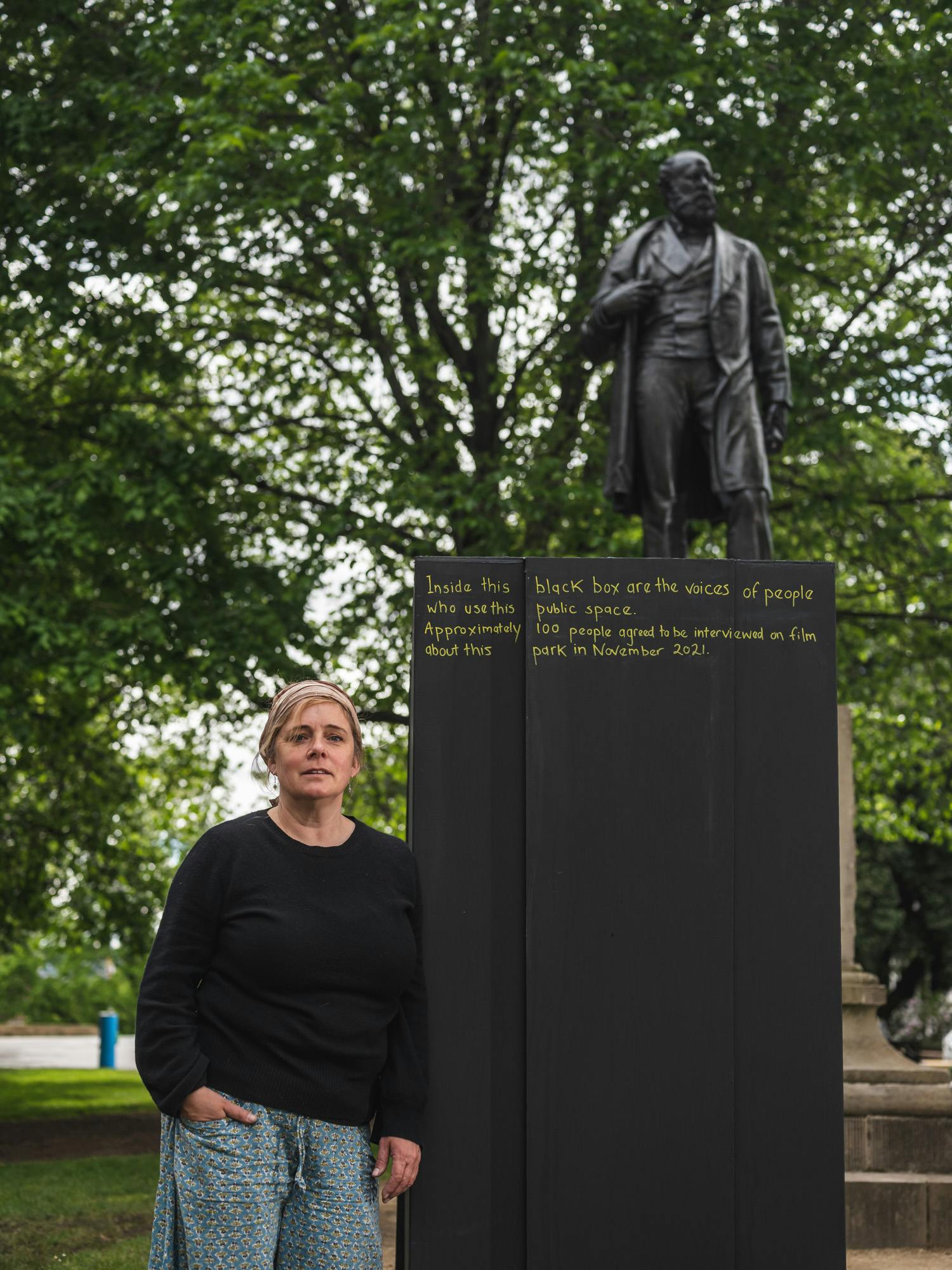 Artist Jillian Mundy stands adjacent her artwork: Something Missing 2021