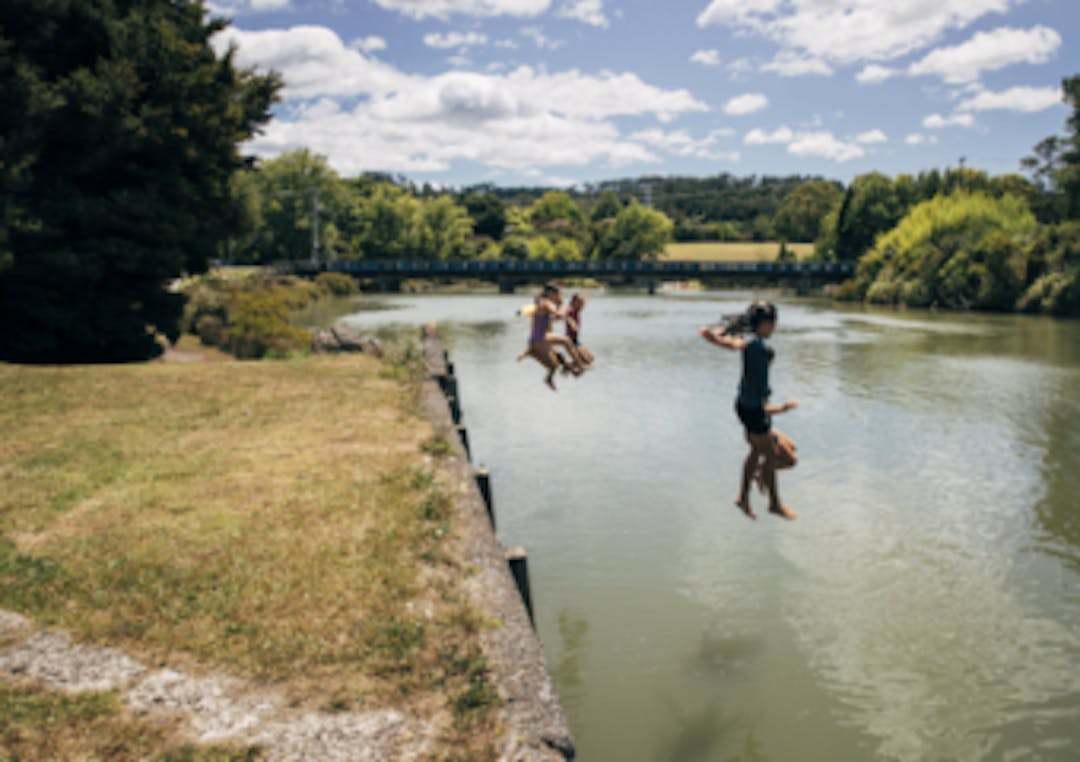 Children jumping into the river on a summer day Children jumping into the river on a summer day