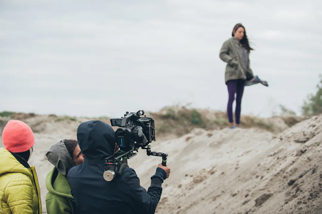 Film crew on beach dunes