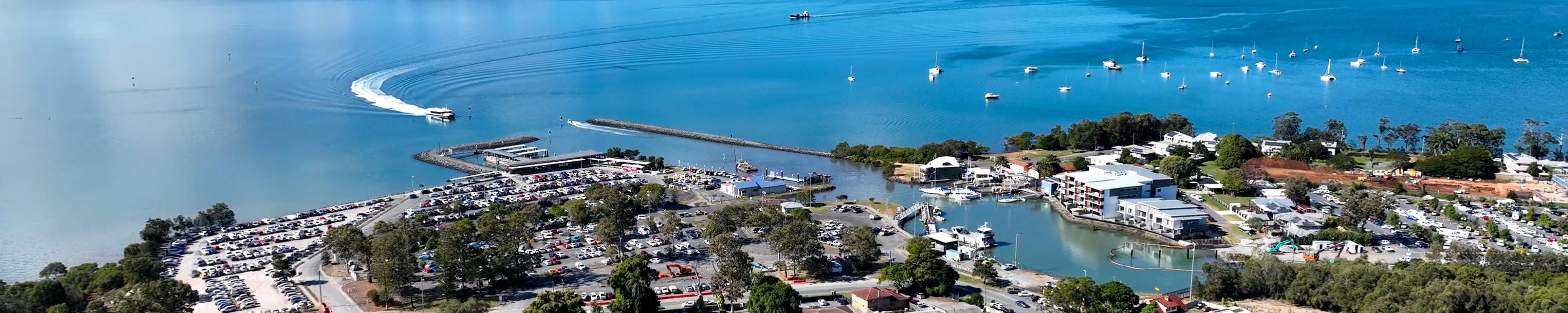 Coastal areal shot of the Redlands, ferry approaching the terminal.
