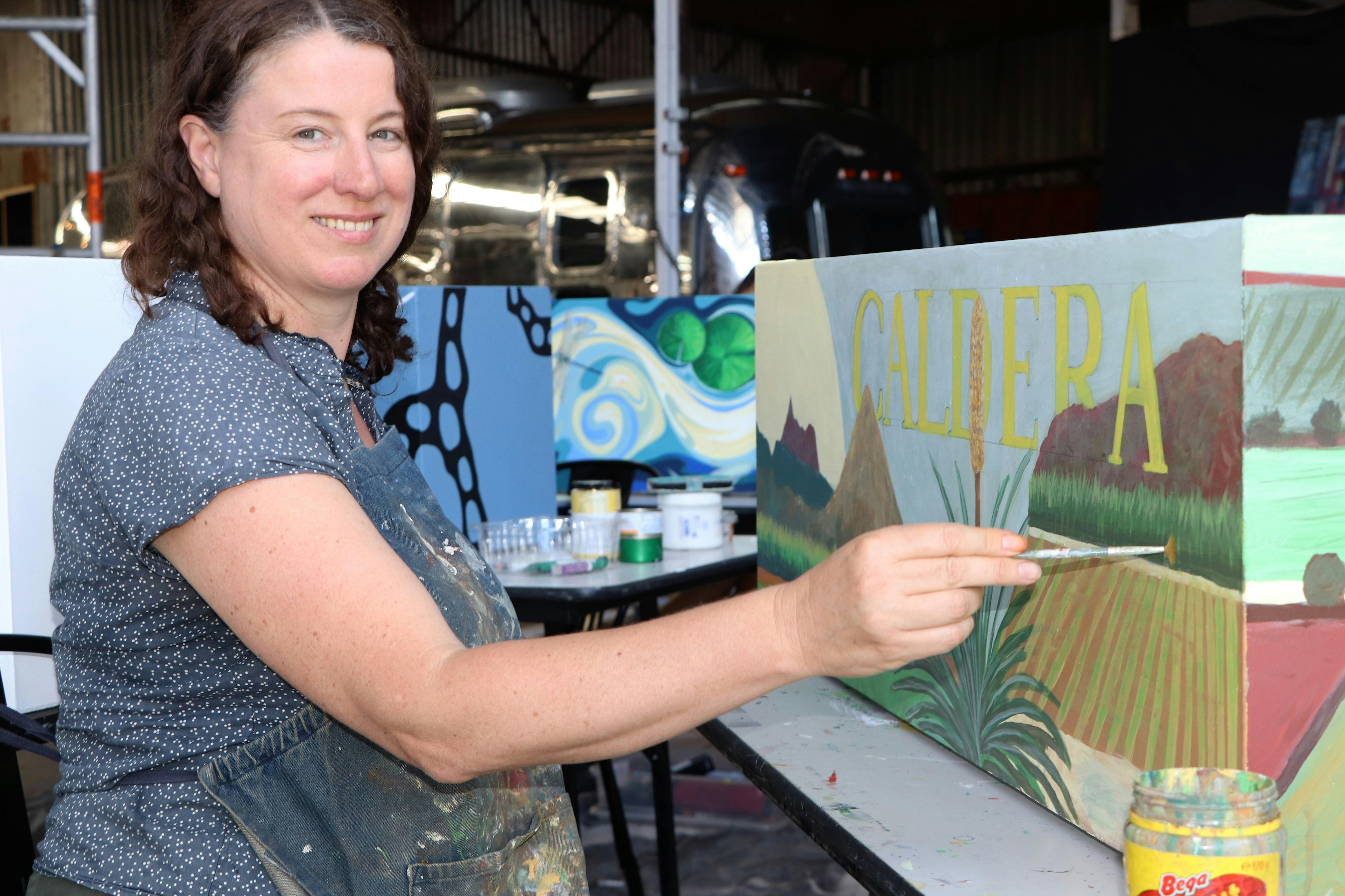 Judy Oakenfull painting her land themed planter box