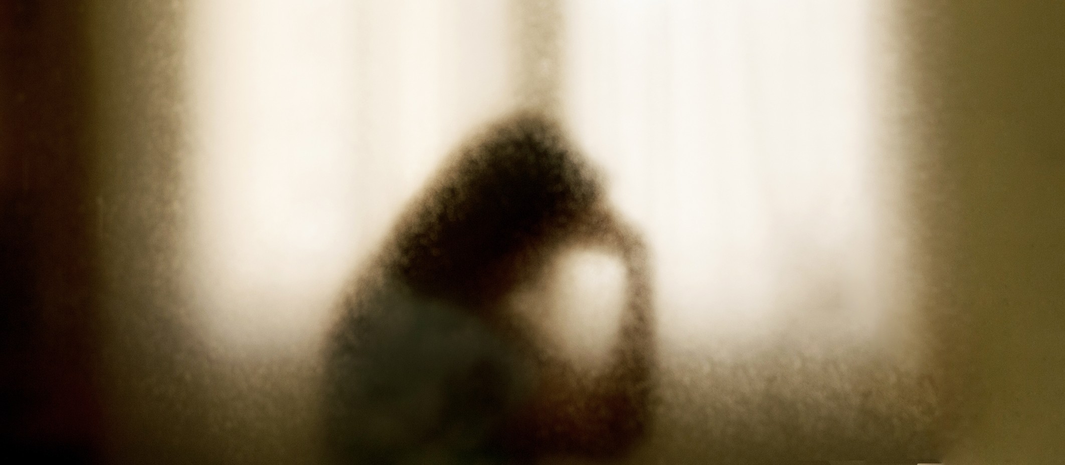 Homeless person behind screen