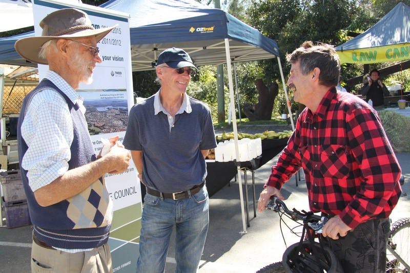 Former Stokers Siding resident Michael Fawsell (left) and Uki Village and Residents Association representative Eddie Roberts (right) give their opinions to the Deputy Mayor, Councillor Barry Longland, at the Uki Markets community information stall.