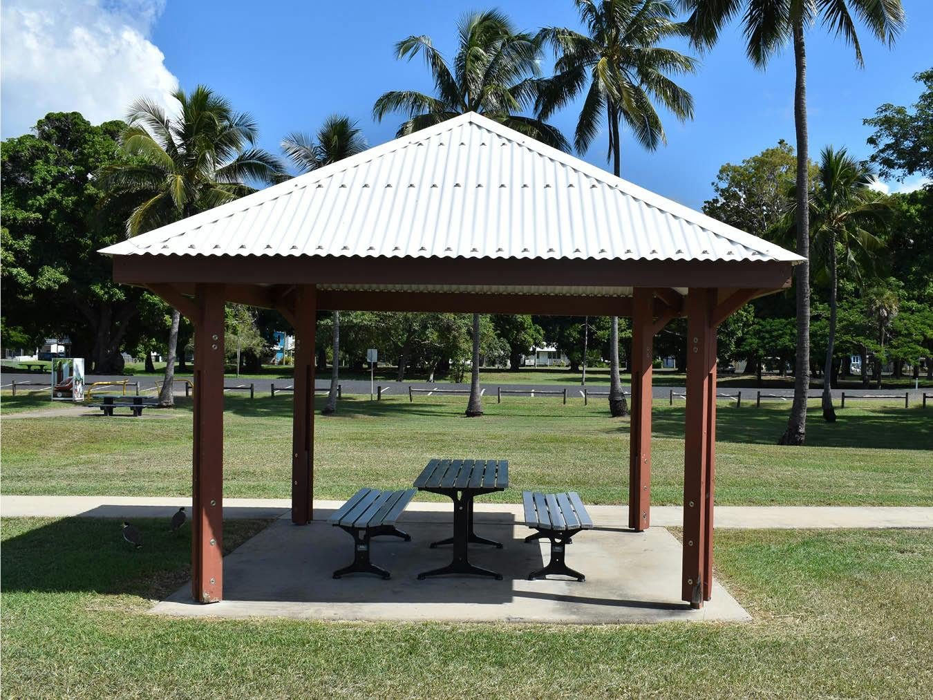 Picnic area - This photograph is looking south towards the car parking area along Seaforth Esplanade Road. This smaller sized shelter includes a single contemporary style picnic setting. 