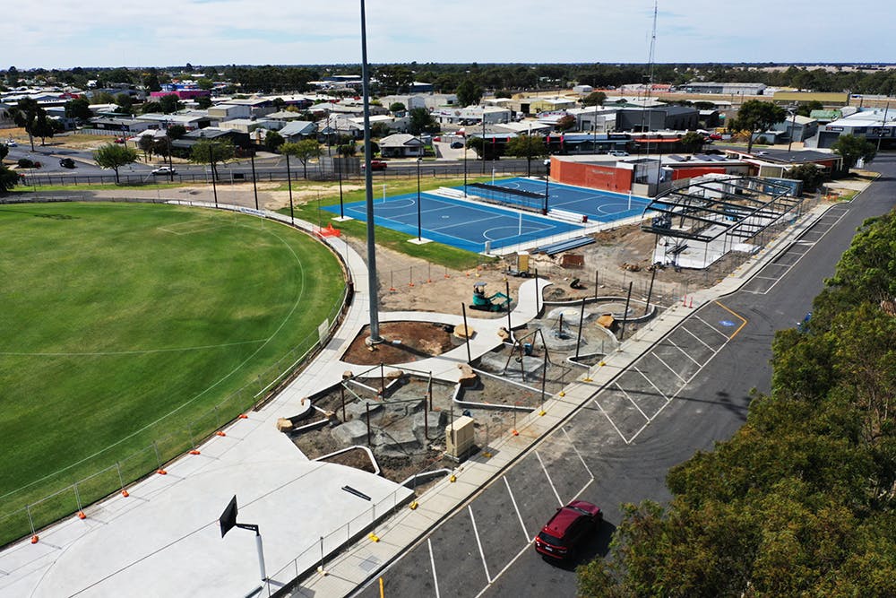 City Oval netball pavillion framing stage with playground.png