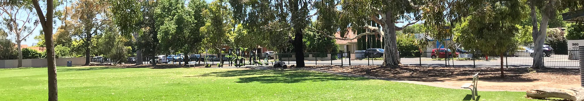 open green space at Page Park, trees and side fencing