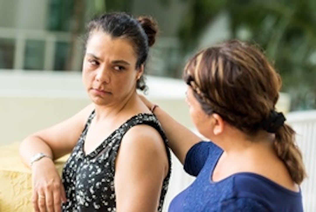 A woman comforting another