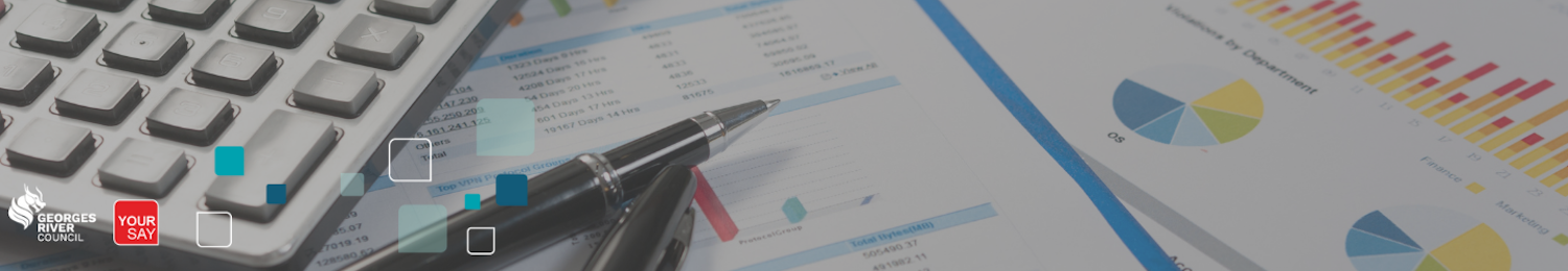 a shot of a desk with calculator, pens and reporting papers across it.