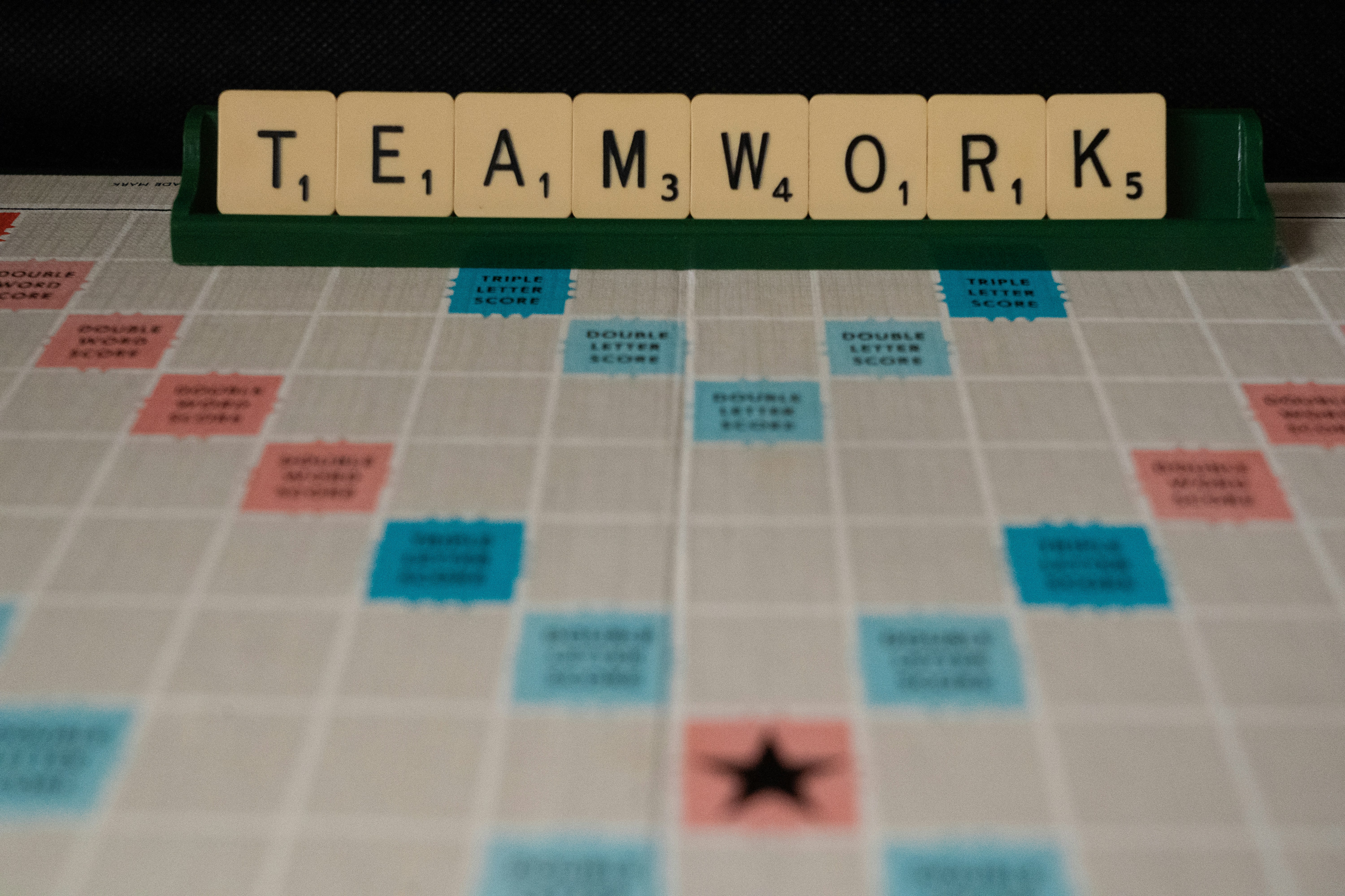 Game board with tiles that spell out Teamwork
