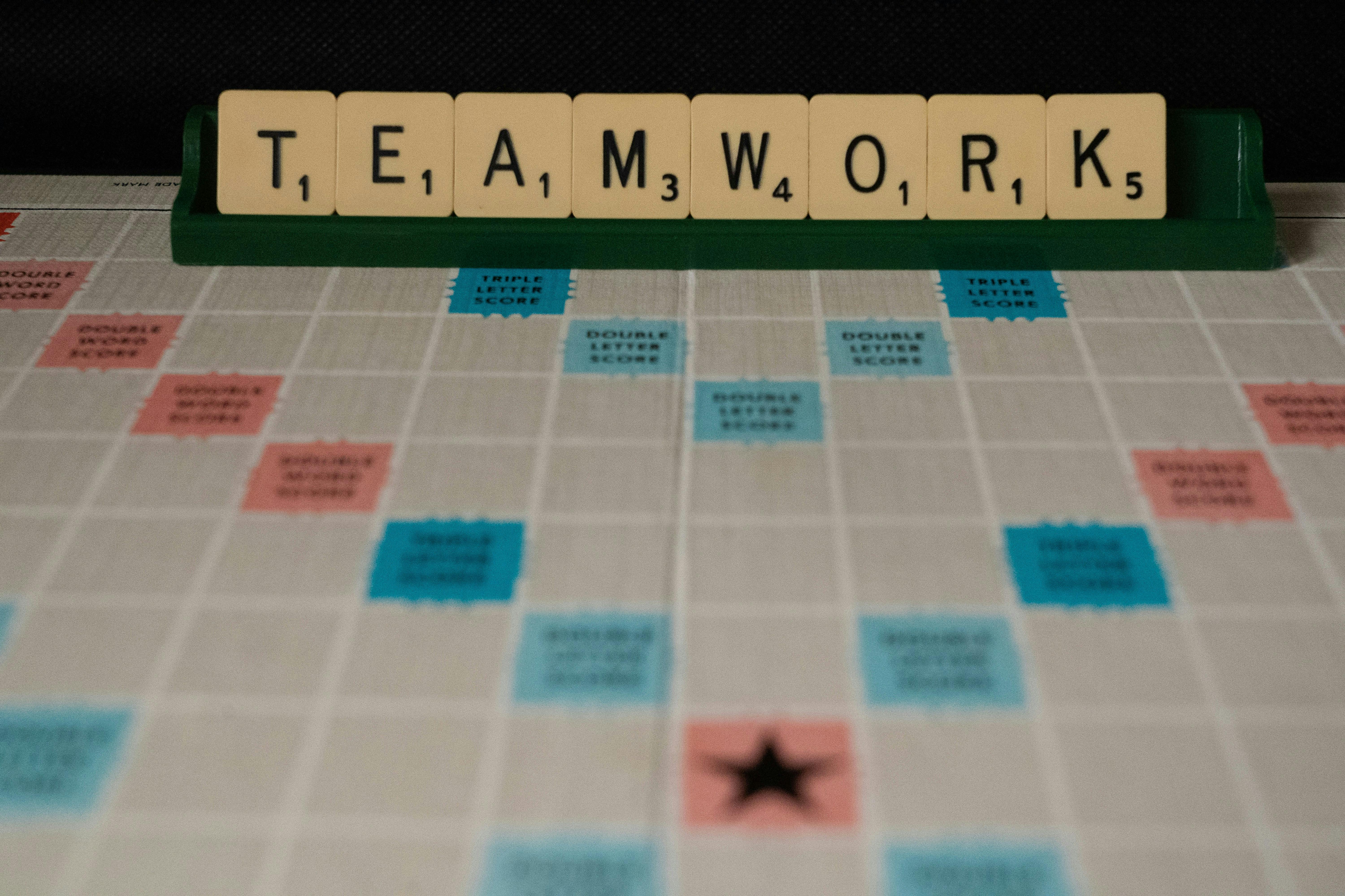 Game board with tiles that spell out Teamwork