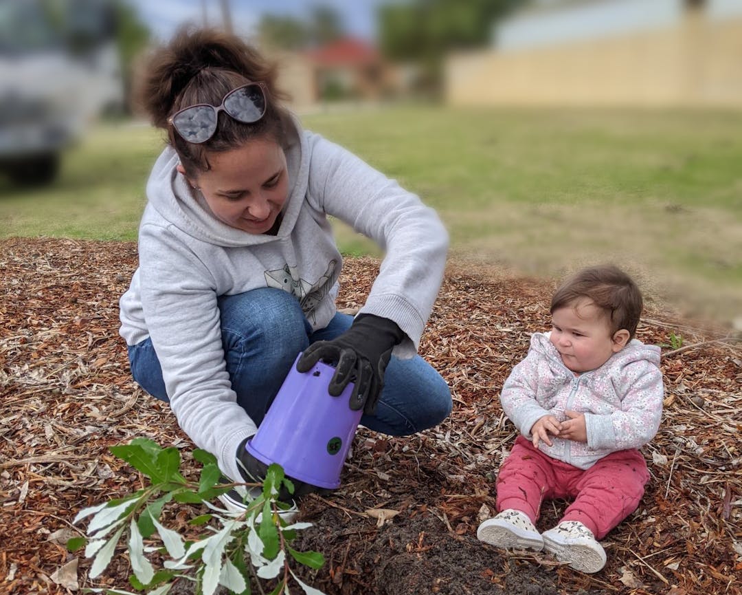 Mother and child planting a commemorative tree