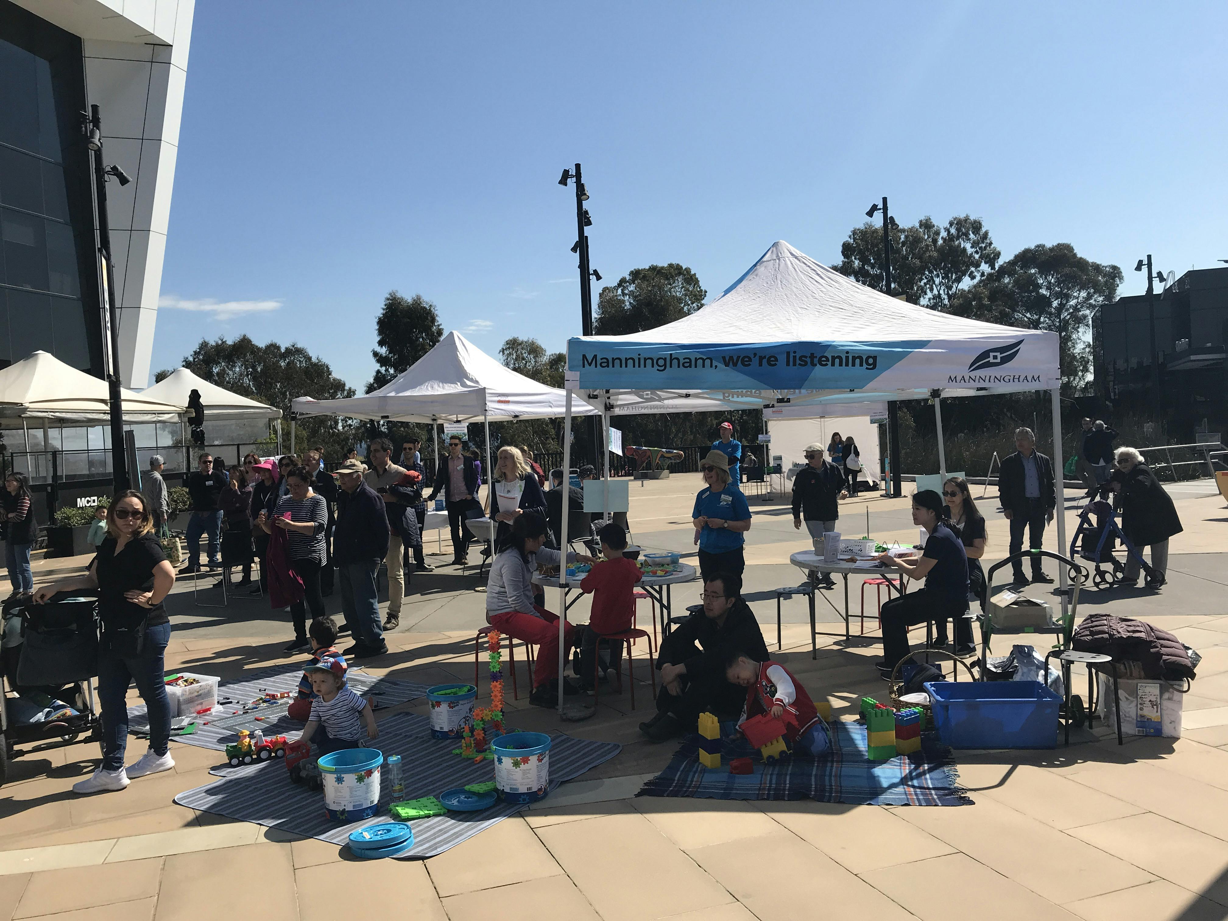 Children doing craft under marquees at MC2