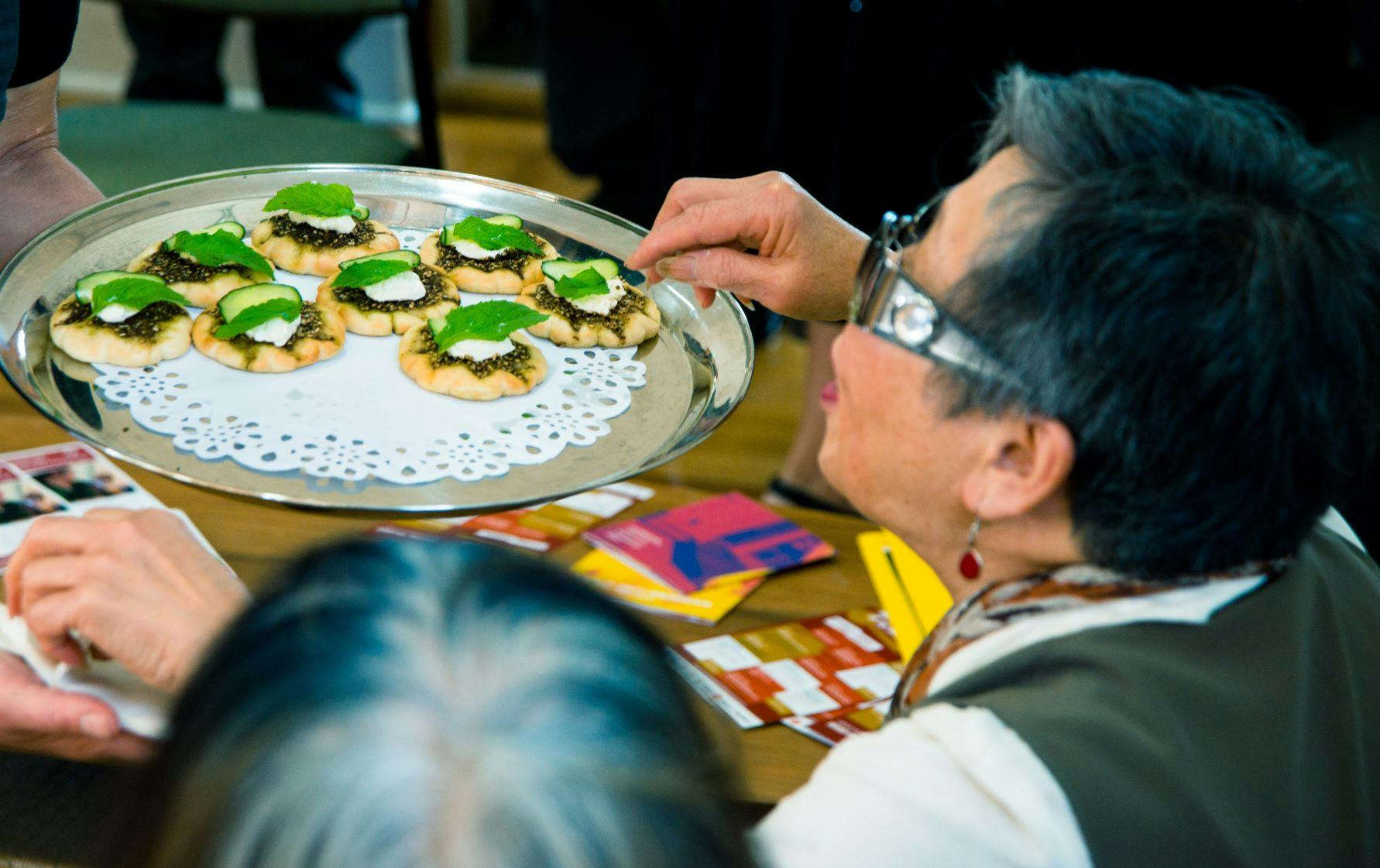 Woman being served finger food at the launch of Moonah Taste of the World 2021