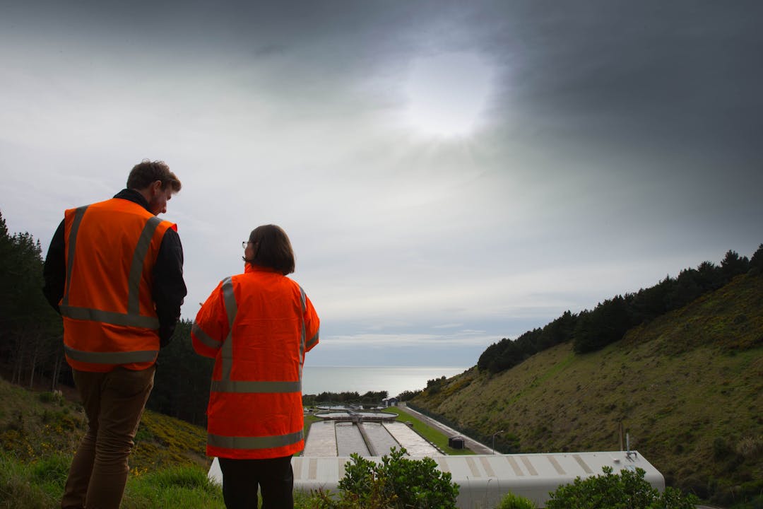 2 people overlooking our wastewater plant