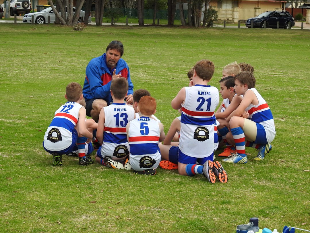 High Wycombe Junior Football Club in a huddle with their coach