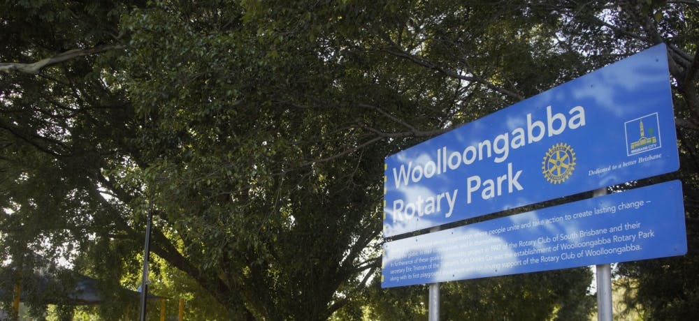 Woolloongabba Rotary Park blue Brisbane City park sign with tree in background.  