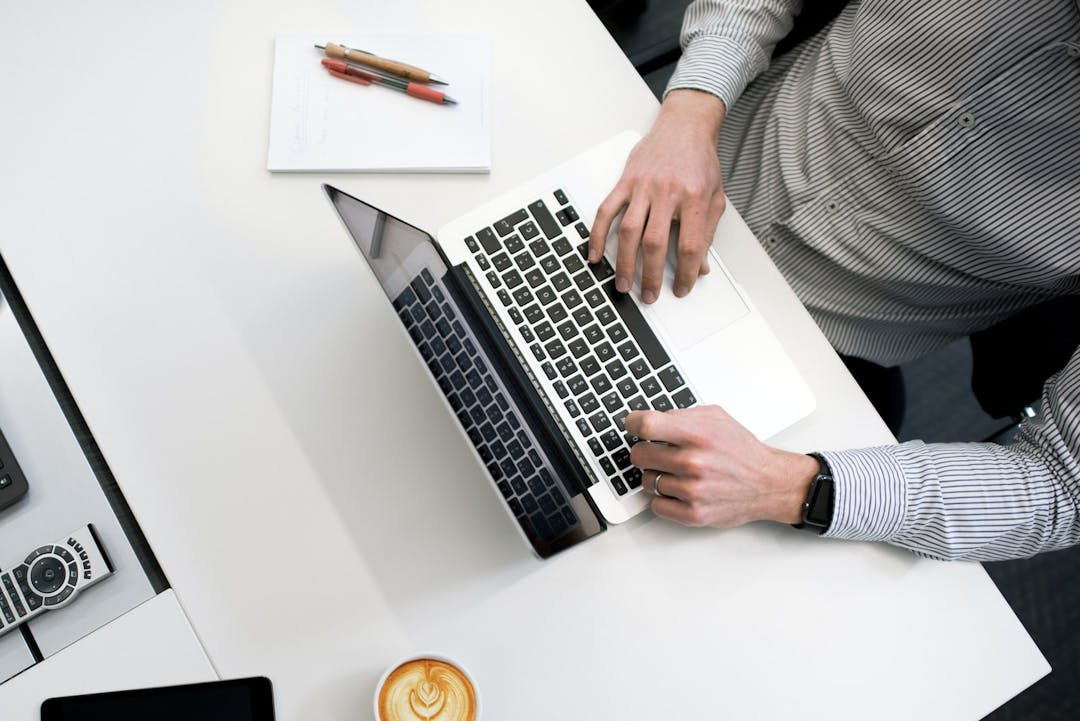 Photo of a person at a computer.