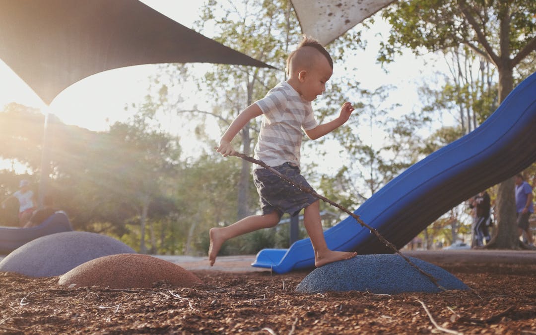 child jumping in playground