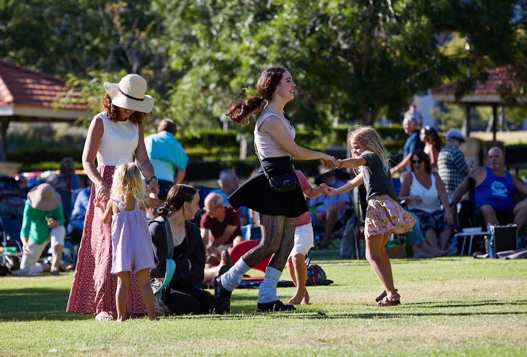 Community members dancing in park