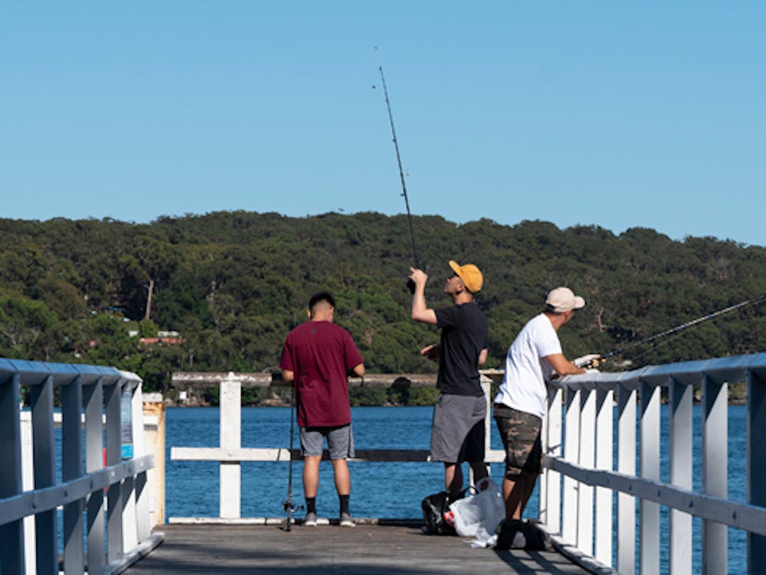 Men fishing off the end of pier