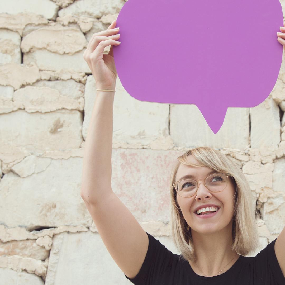 Man holding blue speech bubble